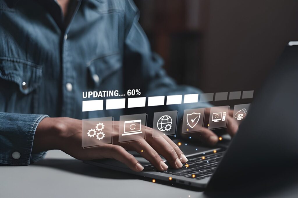 Person updating software on a laptop