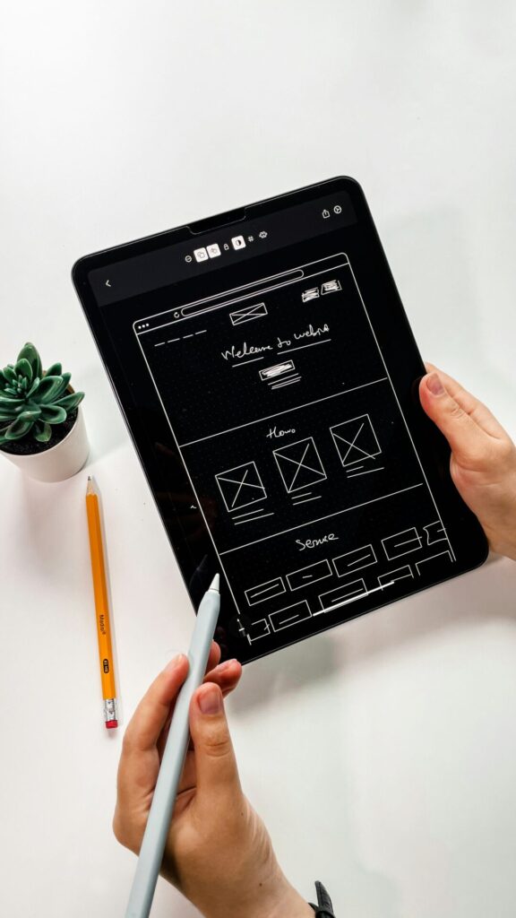 Website wireframe design displayed on tablet during planning stage