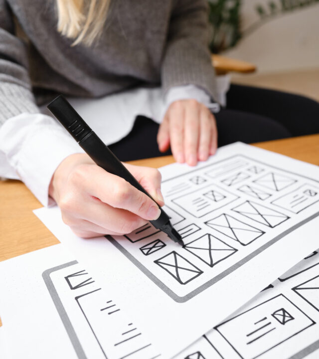 Designing a website layout using wireframes and page structure sketches